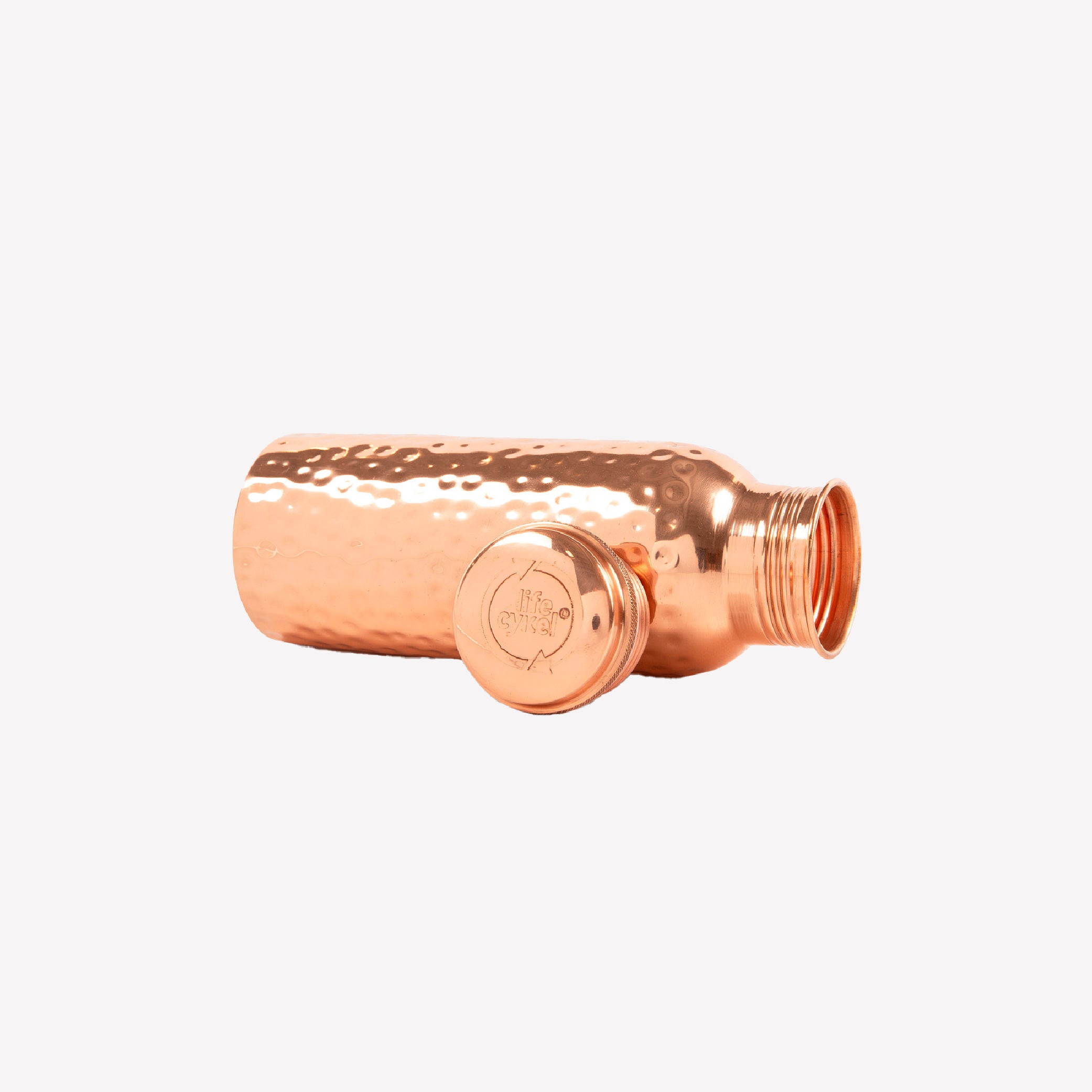Copper water bottle with textured design on a white background